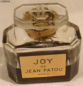 Photo of Joy bottle showing JP logo on glass stopper